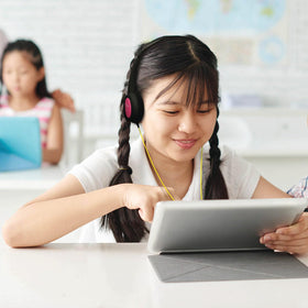 Maxell child using headphones on tablet showing safe listening benefit