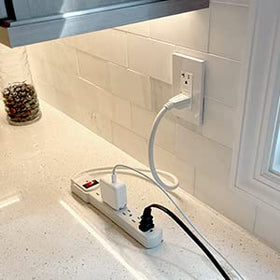 Maxxima outlet detail showing three-prong grounded sockets for safer device connection