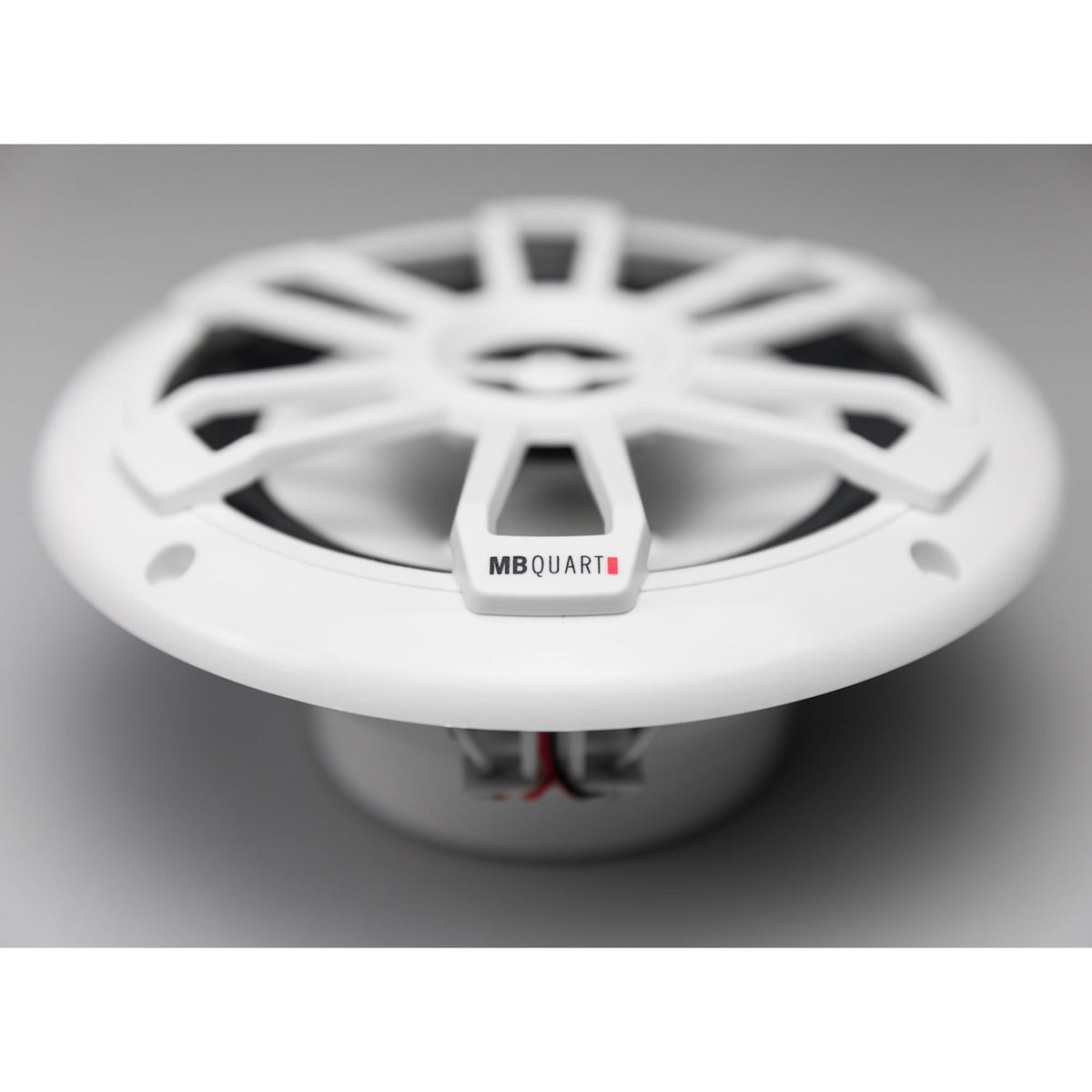 MB Quart with ruler for scale highlighting compact 6.5-inch fitment benefit