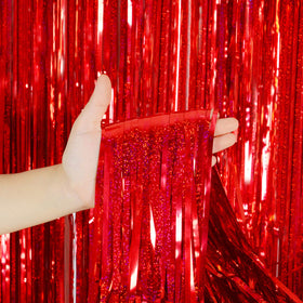 Melsan red fringe curtain layered on wall for dramatic photo booth visuals.