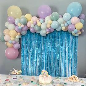 Teal fringe curtain creates a soft shimmering backdrop for a baby shower