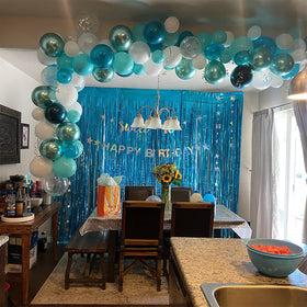 Teal fringe curtain set enhances birthday party décor with easy wall mounting