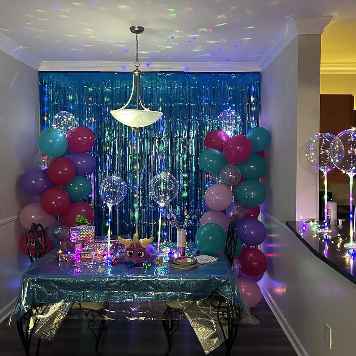 Teal fringe curtain adds depth to graduation party décor