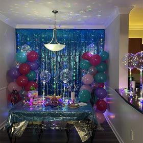 Teal fringe curtain adds depth to graduation party décor