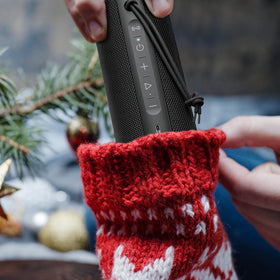 MIATONE next to backpack illustrating portable 24-hour battery advantage