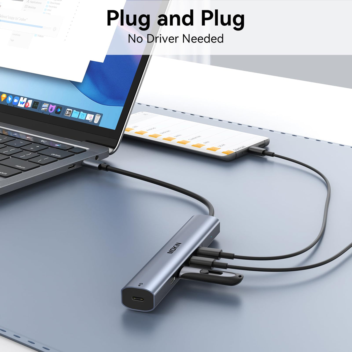 MOKiN hub next to smartphone showing compact size and portable advantage