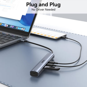 MOKiN hub next to smartphone showing compact size and portable advantage