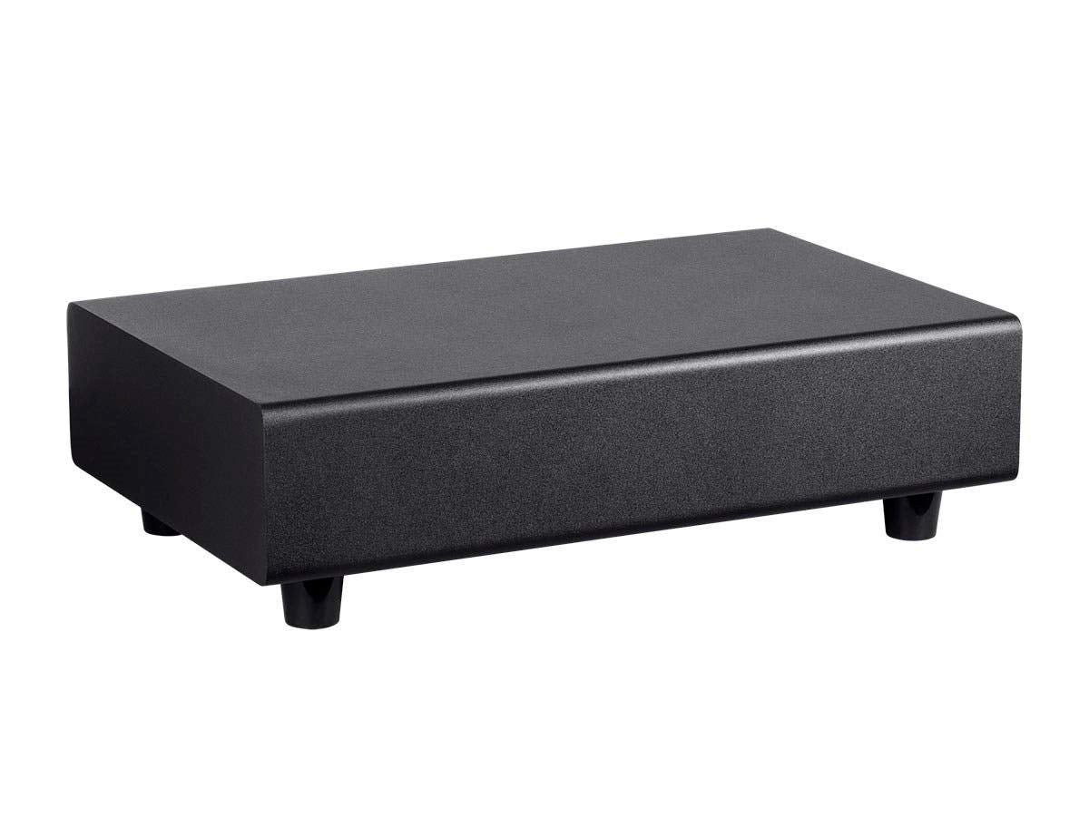 Monoprice SSW-10 under-chair view showing compact bass in a living room setup