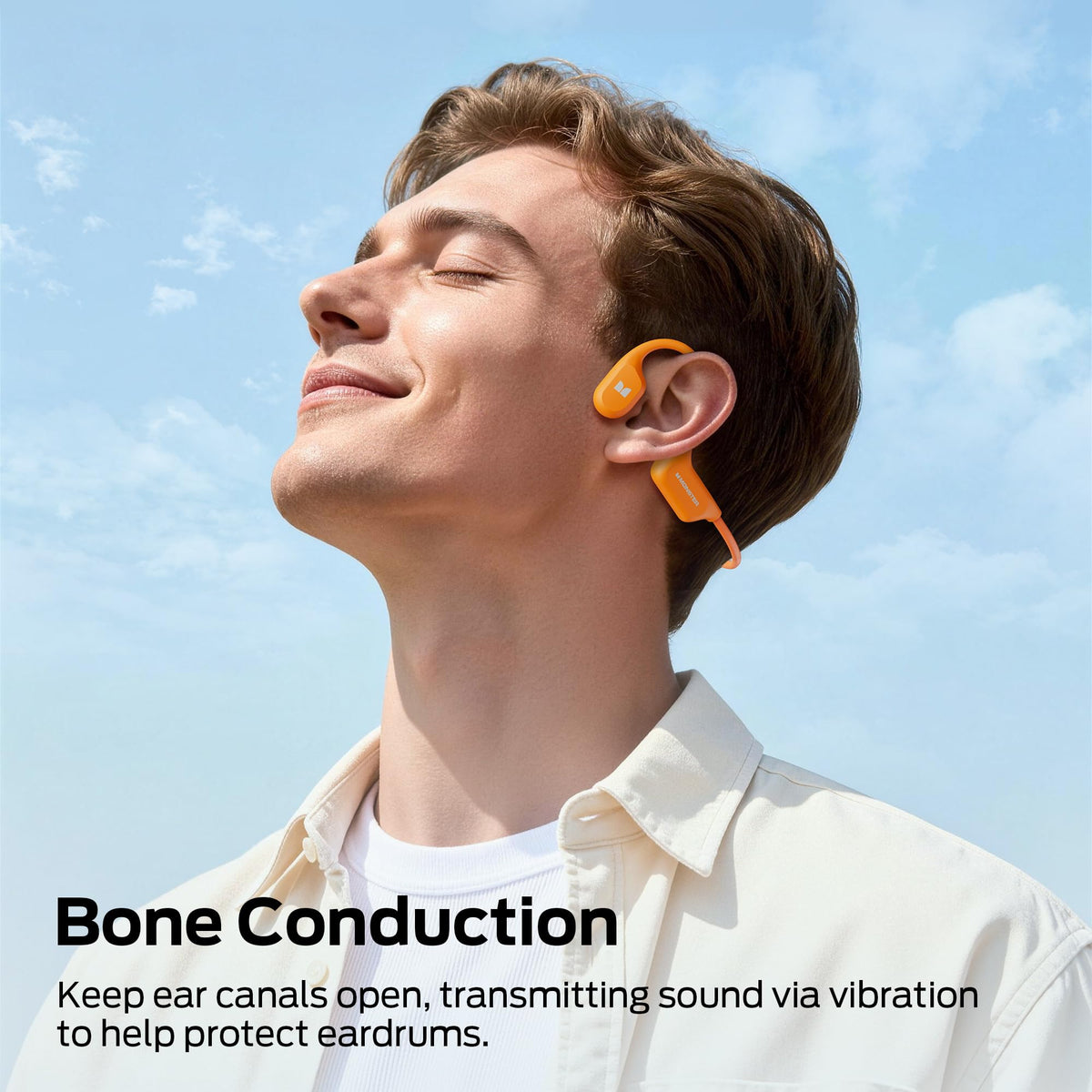 Monster BC300 open-ear headphones on a cyclist, staying aware with bone conduction audio.