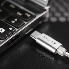Moondrop FreeDSP in a listening setup showing portable hi‑res tuning flexibility