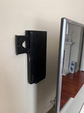 Mount Plus beside a modem for size comparison showing fit for common media boxes