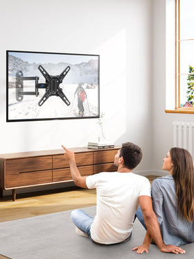 Mounting Dream scale comparison next to a 42-inch TV showing size and weight capacity
