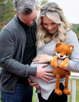 My Baby's Heartbeat Bear fox held by family hands capturing sentimental sharing