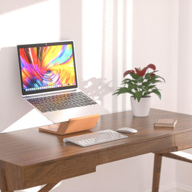 NAMAII next to 15-inch laptop for scale to show compatibility with 10–17 inch devices