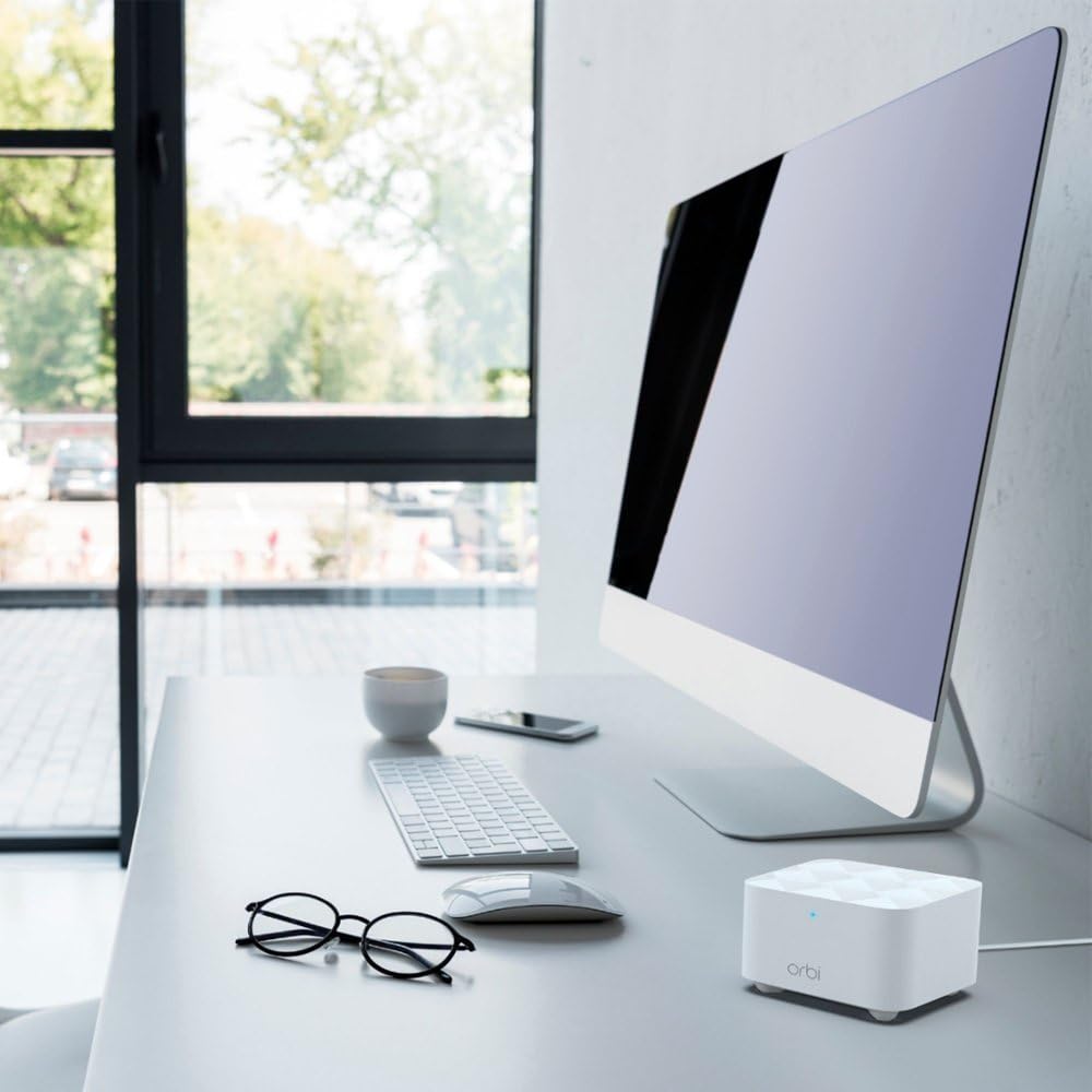 NETGEAR Orbi RBK13 installed in living room showing improved whole‑home Wi‑Fi connectivity