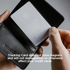 NOMAD tracking card next to passport and boarding pass illustrating travel-ready item location security