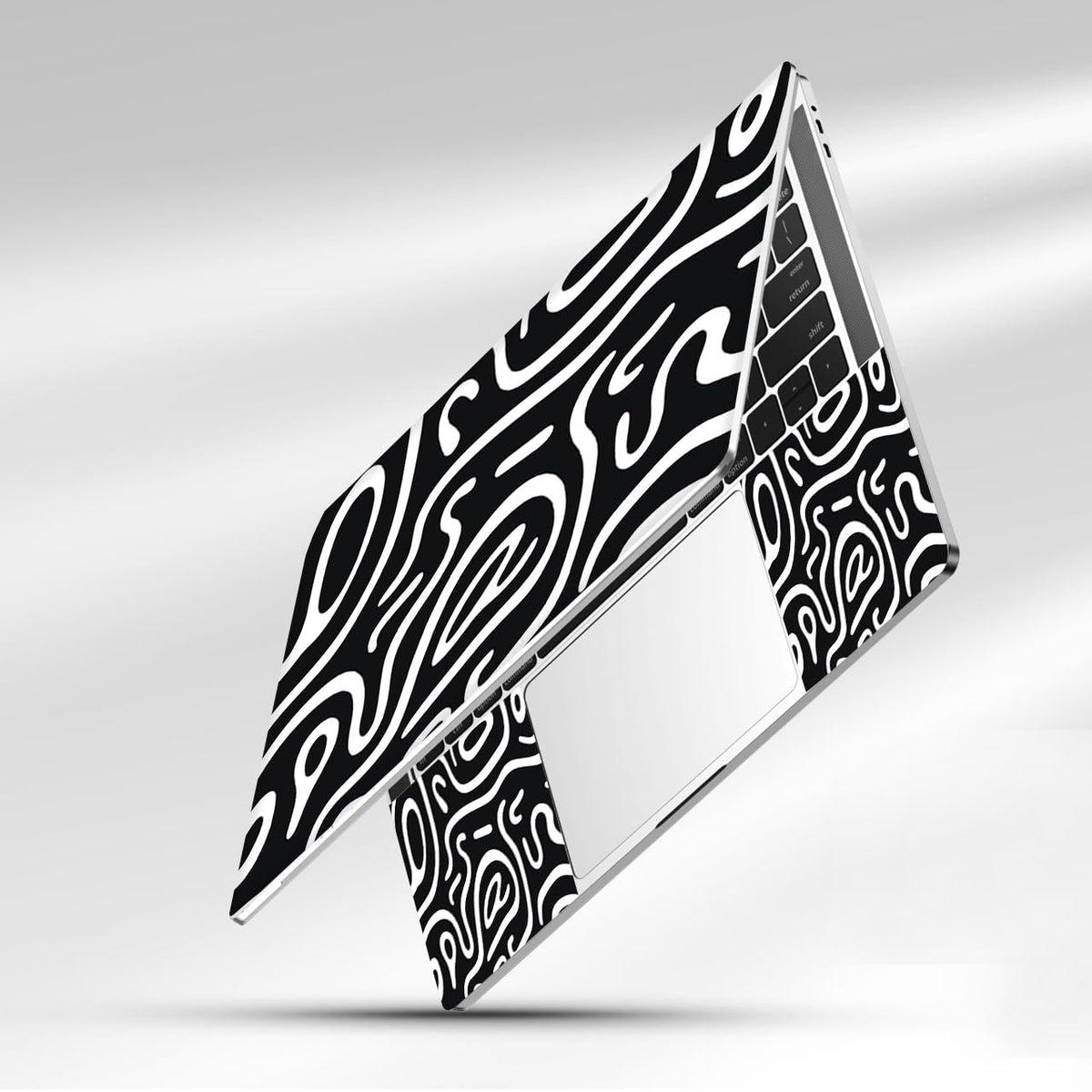 NXZGO desk scene with topographic black laptop skin applied