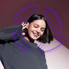 occiam earbuds next to hand showing compact size and portability