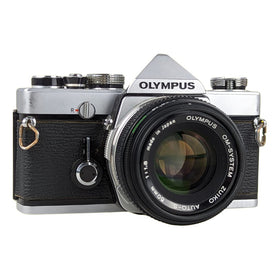 Olympus OM-1 with 50mm f1-8 lens close-up highlighting bright, sharp low-light potential.