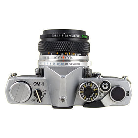 Olympus OM-1 film advance lever close-up showing mechanical feedback.