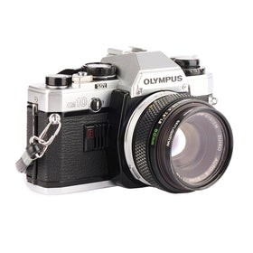 Olympus OM-10 battery compartment emphasizing LR44 power for reliable exposure