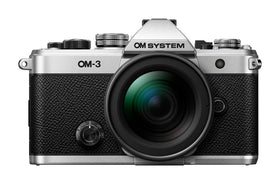 OM SYSTEM OM-3 silver front view showing premium build for travel