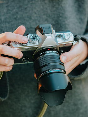 OM SYSTEM OM-3 with 12-45mm mounted offers versatile zoom for urban and outdoors