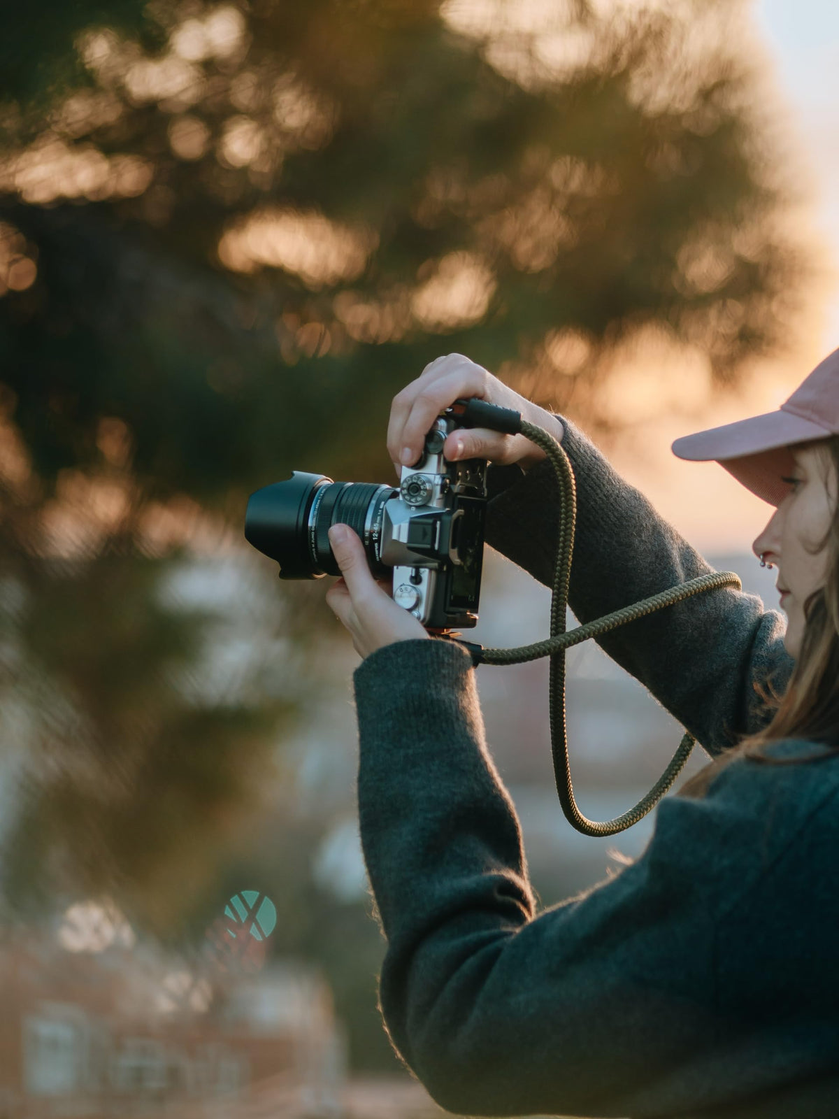 OM SYSTEM OM-3 silver side profile highlighting ergonomic grip for all-day shooting