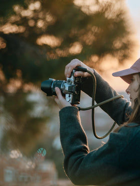 OM SYSTEM OM-3 silver side profile highlighting ergonomic grip for all-day shooting