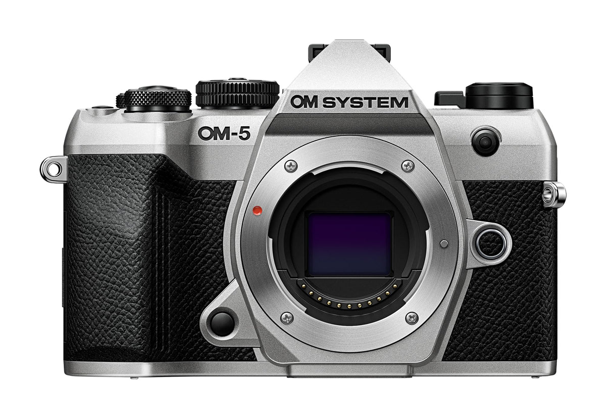 OM System OM-5 Mark II silver body ready for travel photography.