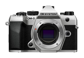 OM System OM-5 Mark II silver body ready for travel photography.