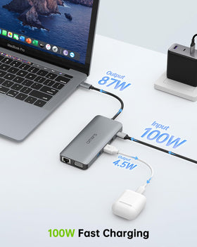 Omars hub beside a laptop illustrating scale and portable multiport convenience