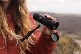 Opticron Explorer WA ED-R 8x42 side view emphasizing ergonomic grip for wearers.