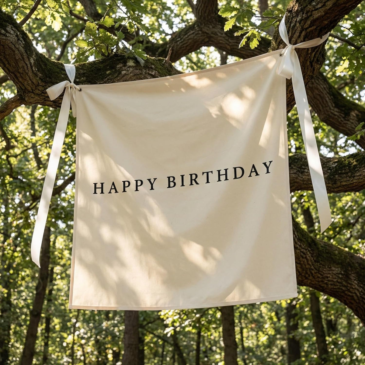 Oudain burlap birthday banner on wall as rustic celebration backdrop.
