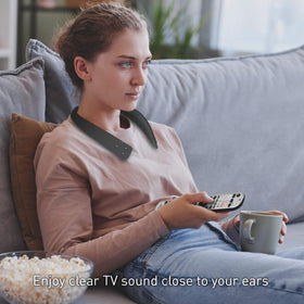 Person wearing Panasonic WN10 in living room enjoying TV with hands-free comfort