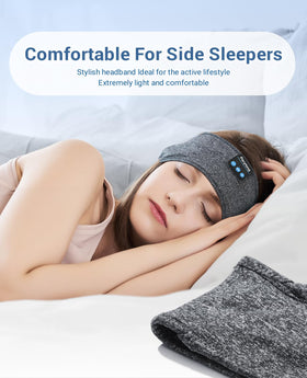 Perytong Sleep Headphones in bed with user wearing headband for comfort.