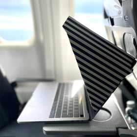 Philbert on a beach laptop blocking sun and lowering screen heat benefit