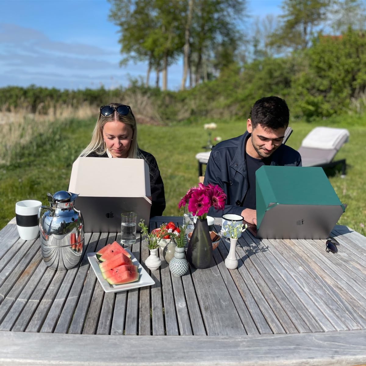 Philbert Slim Hood on laptop at beach reducing sun and screen heat