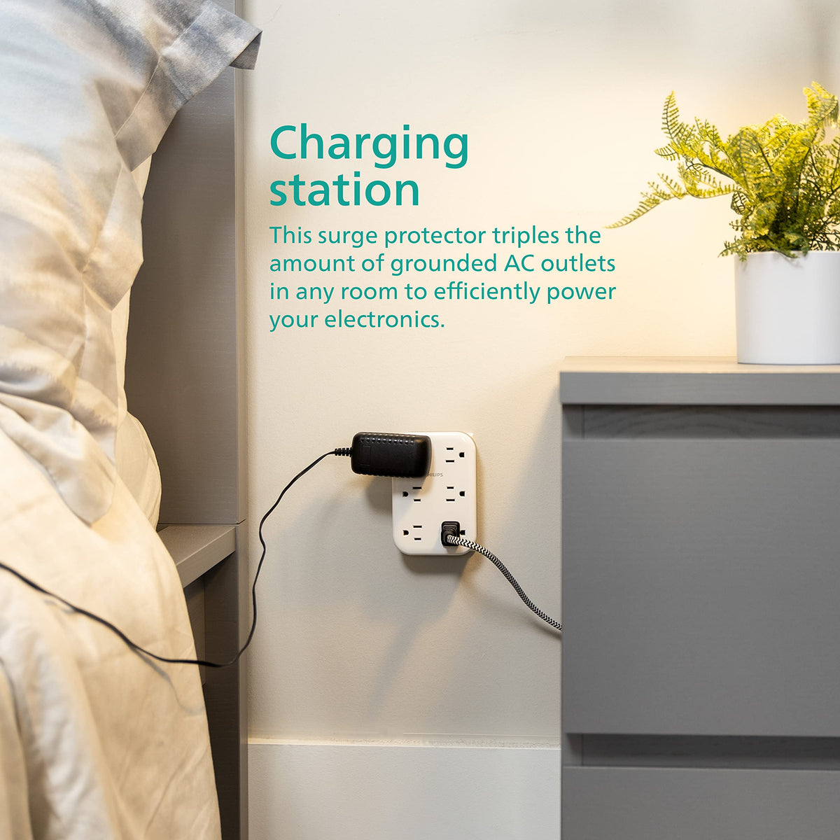 PHILIPS EZFit used as a charging hub with phone and laptop plugged in for organized power