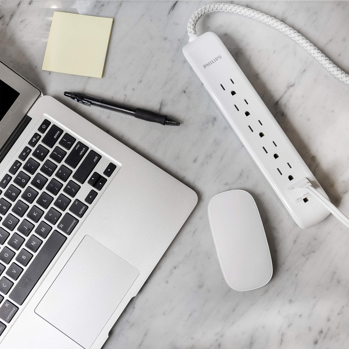 PHILIPS in-use entertainment setup powering TV and console with surge protection benefit