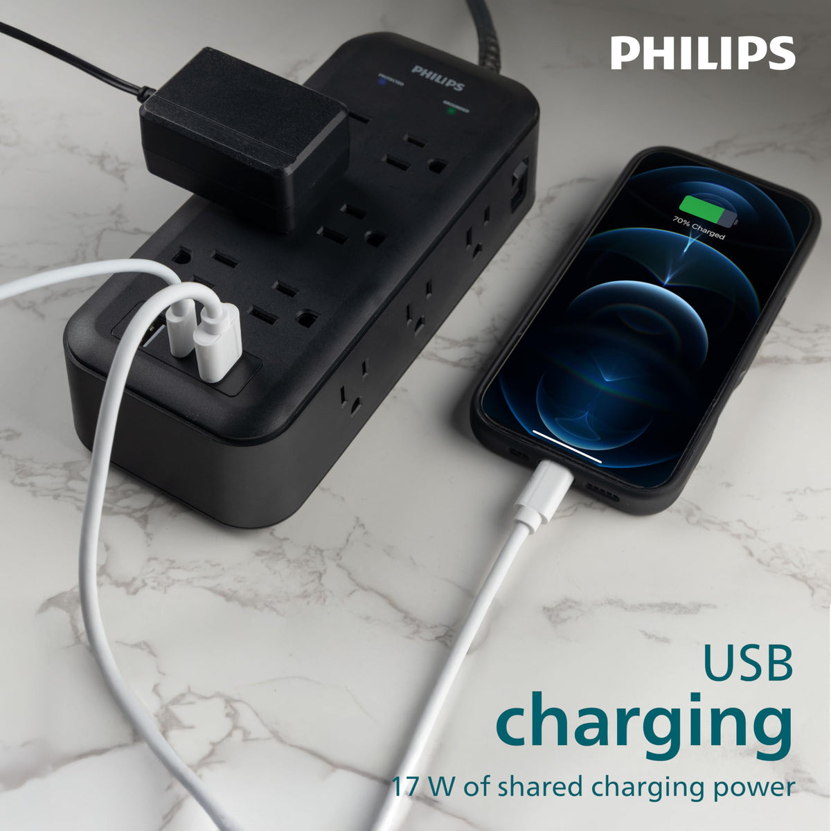 PHILIPS power strip powering desk monitors and laptop in a home office for tidy cable management