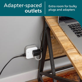 PHILIPS surge tap plugged into wall powering home office devices for neat organization