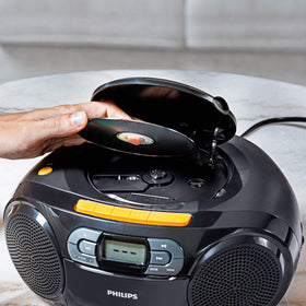 PHILIPS travel-ready boombox shown outdoors for on-the-go listening.