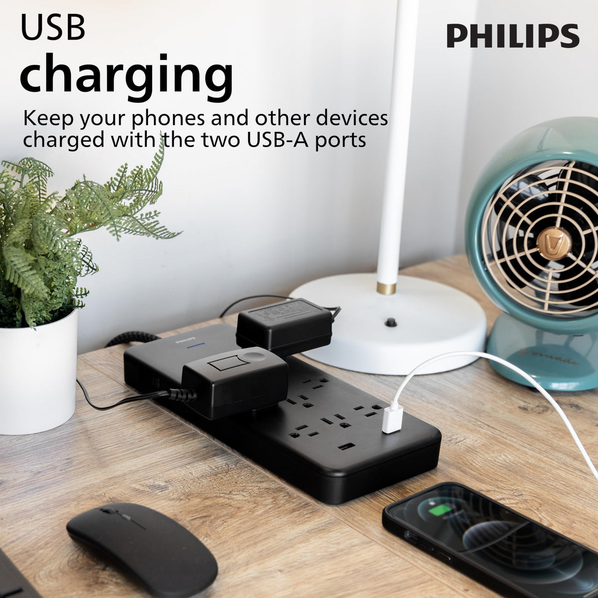 Philips size comparison next to laptop demonstrating compact footprint and scale