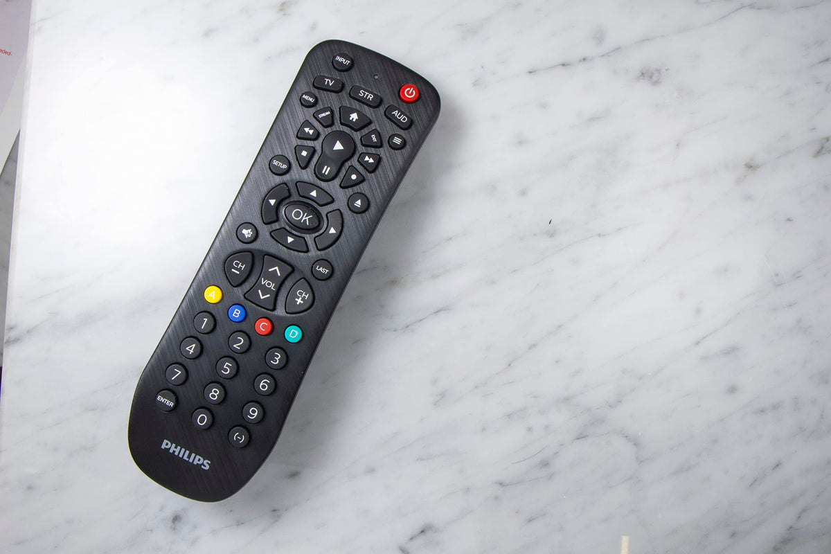 Philips remote with packaging and manual illustrating simple setup benefit