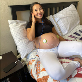 Pixie Tunes speakers on belly in use enabling parents to play music safely