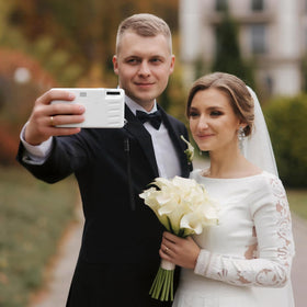 PJPSAA white disposable camera with hand strap enables easy handheld use.