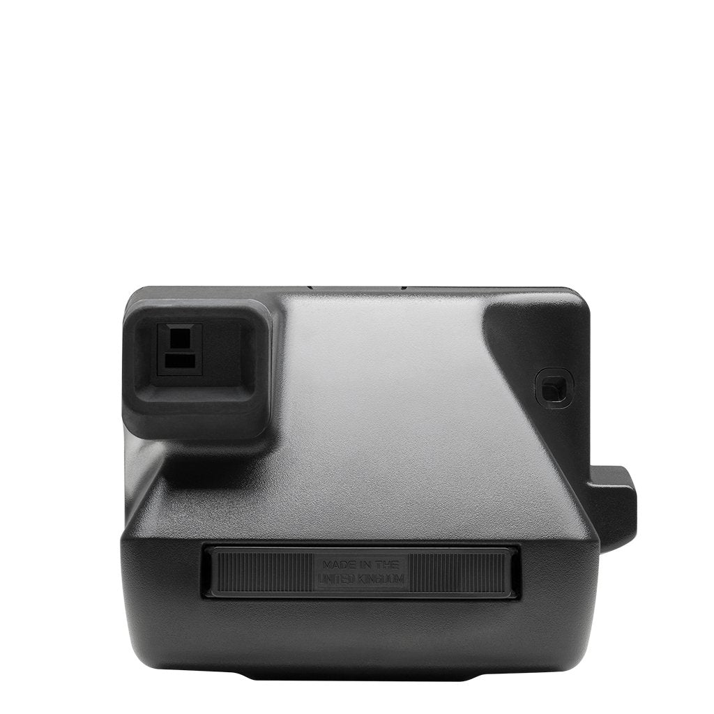 Polaroid 600 OneStep ejecting film with Impossible shield protecting the developing print