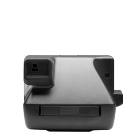 Polaroid 600 OneStep ejecting film with Impossible shield protecting the developing print
