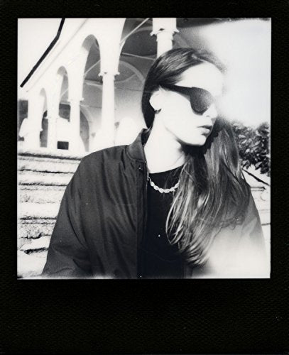 Polaroid 600 OneStep held in hand to show size and portable shooting convenience